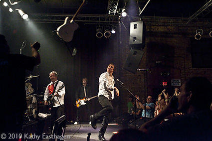 Steve Diggle, throws his guitar to the guitar tech at the end of the show